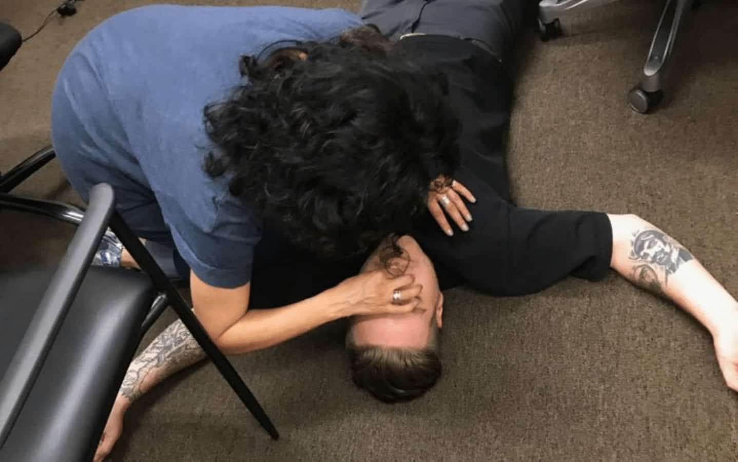 woman administering cpr to man who overdosed on drugs
